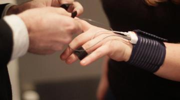 A hand and wrist showing the Shimmer biometric monitoring device